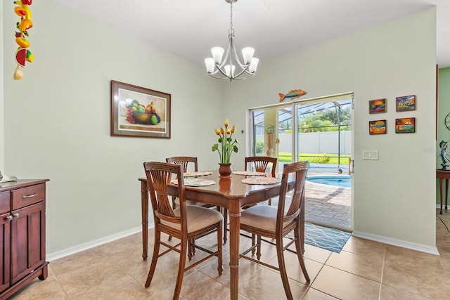 tiled dining space with a chandelier