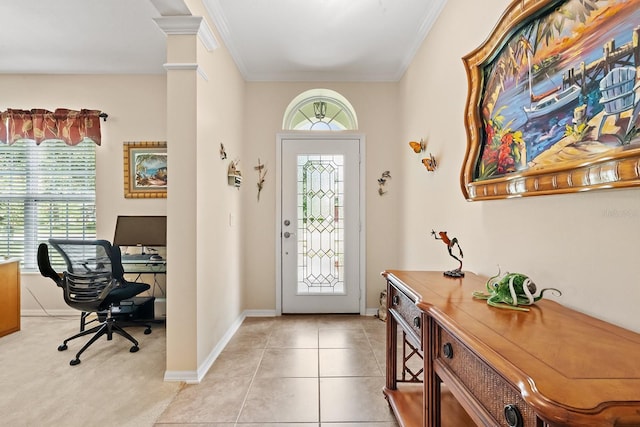 foyer entrance with ornate columns, crown molding, light tile patterned floors, and a healthy amount of sunlight