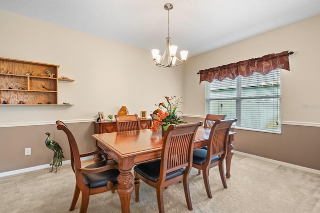 dining area with light colored carpet and an inviting chandelier