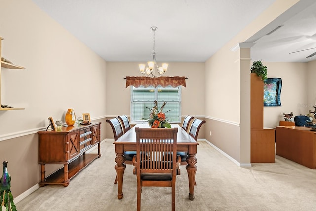 dining space featuring light carpet and ceiling fan with notable chandelier