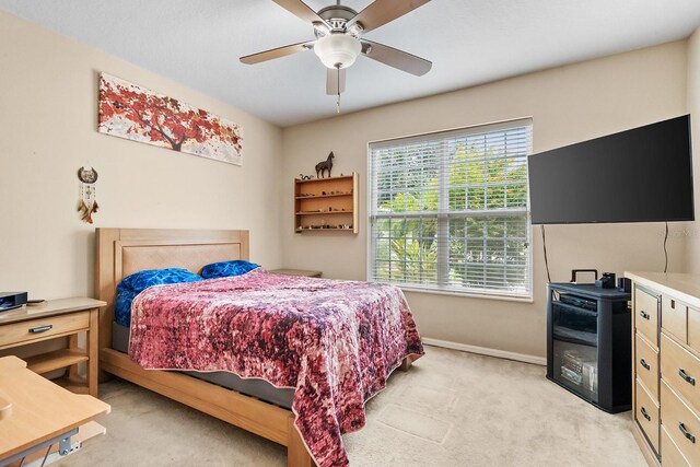 bedroom featuring ceiling fan and light colored carpet