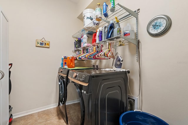 laundry area with light tile patterned floors and washing machine and dryer