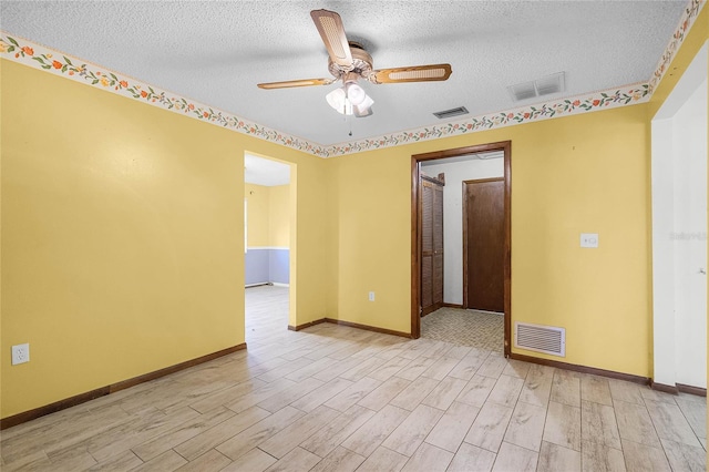 1005 Crescent Pkwy, Deland, FL 32724 - spare room featuring light wood-style floors, a textured ceiling, and visible vents