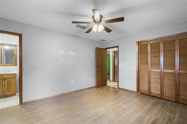 1005 Crescent Pkwy, Deland, FL 32724 - unfurnished bedroom featuring visible vents, light wood-type flooring, a sink, baseboards, and a closet