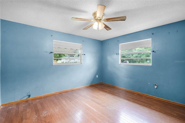 1005 Crescent Pkwy, Deland, FL 32724 - spare room with ceiling fan, a healthy amount of sunlight, and hardwood / wood-style flooring