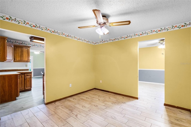 1005 Crescent Pkwy, Deland, FL 32724 - spare room with a textured ceiling, ceiling fan, and light wood-type flooring