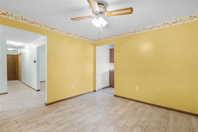 1005 Crescent Pkwy, Deland, FL 32724 - spare room with baseboards, a ceiling fan, light wood-style flooring, and a textured ceiling