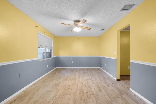 1005 Crescent Pkwy, Deland, FL 32724 - unfurnished room featuring a textured ceiling, a ceiling fan, baseboards, wood finished floors, and visible vents