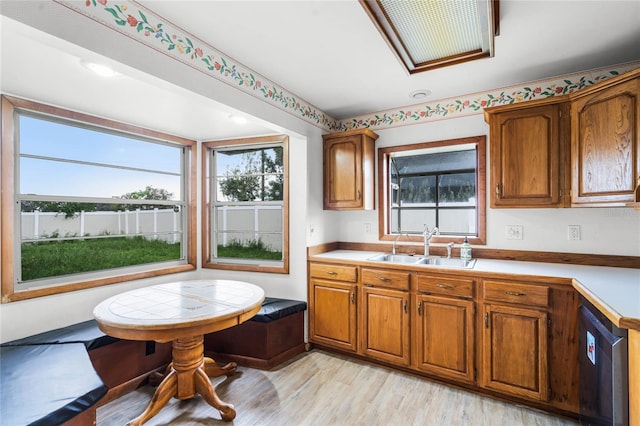 1005 Crescent Pkwy, Deland, FL 32724 - kitchen featuring brown cabinets, a healthy amount of sunlight, a sink, and light countertops