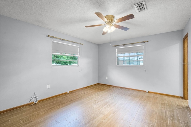 1005 Crescent Pkwy, Deland, FL 32724 - spare room featuring baseboards, visible vents, plenty of natural light, and light wood-type flooring