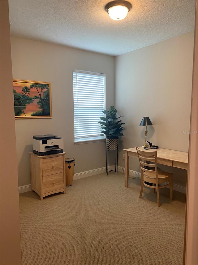 home office featuring light colored carpet and a textured ceiling