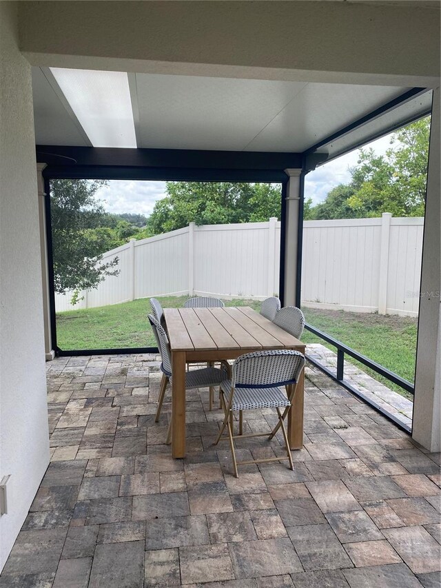 view of patio with outdoor dining area and fence