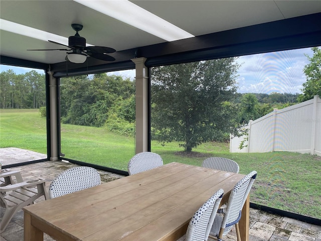 view of patio / terrace featuring fence, ceiling fan, and outdoor dining area