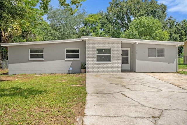 ranch-style house with a front lawn