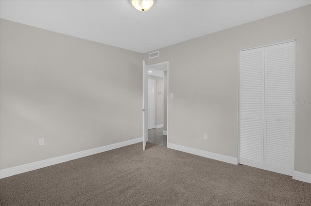 unfurnished bedroom featuring carpet and a closet