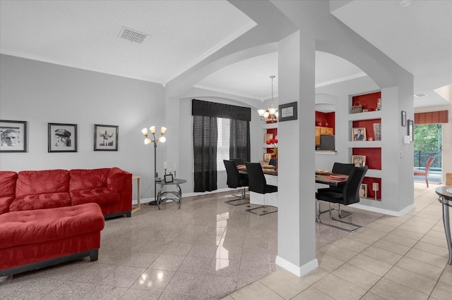 living room featuring ornamental molding and a chandelier