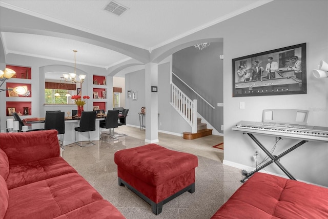 living room featuring built in features, a notable chandelier, and ornamental molding