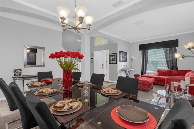 dining space with ornamental molding and a notable chandelier