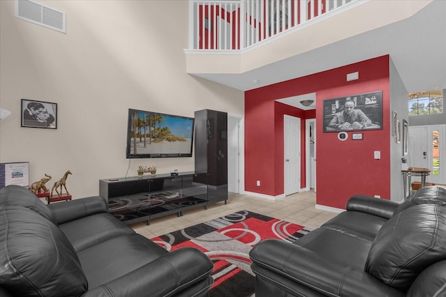 tiled living room featuring a high ceiling