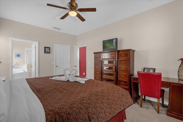 bedroom featuring ceiling fan, connected bathroom, and light carpet