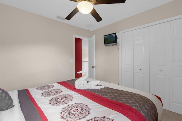 carpeted bedroom with a closet and ceiling fan