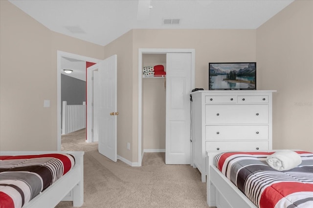 bedroom featuring a closet and light carpet