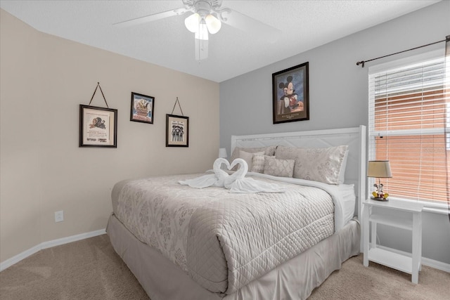 carpeted bedroom with a textured ceiling and ceiling fan