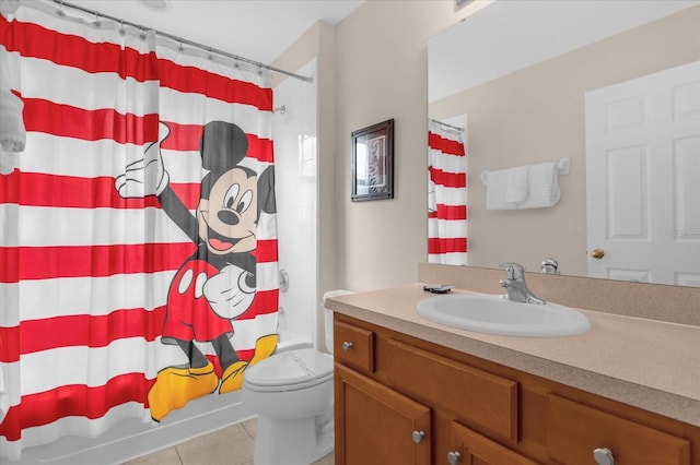 full bathroom featuring tile patterned flooring, vanity, toilet, and shower / bath combo with shower curtain