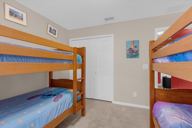 carpeted bedroom with a closet