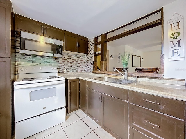 kitchen featuring backsplash, white electric stove, sink, light tile patterned flooring, and dark brown cabinetry