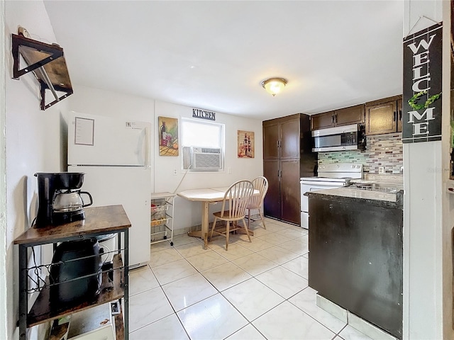 kitchen featuring cooling unit, light tile patterned flooring, white appliances, and tasteful backsplash