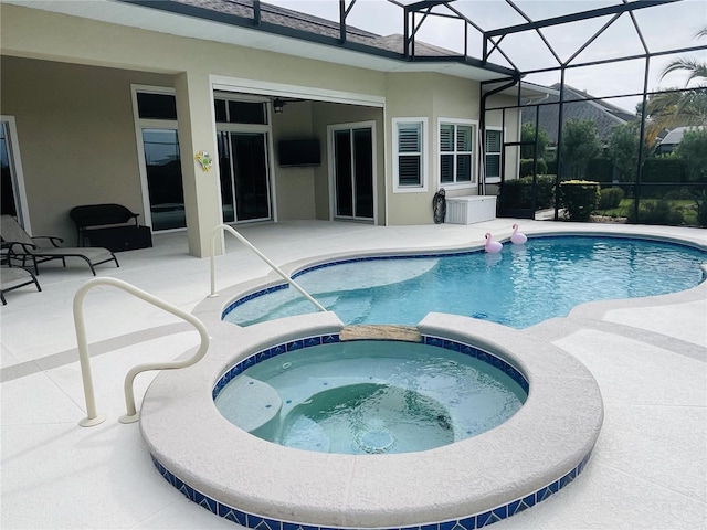 view of swimming pool with glass enclosure, an in ground hot tub, and a patio area