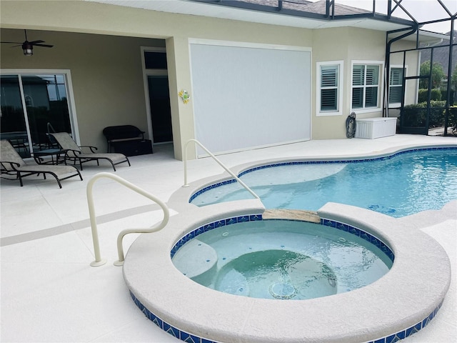 view of pool featuring glass enclosure, an in ground hot tub, and a patio