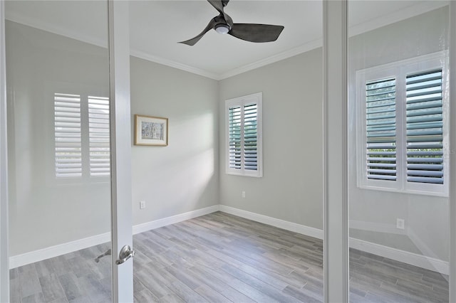 spare room with light hardwood / wood-style flooring, ceiling fan, and ornamental molding