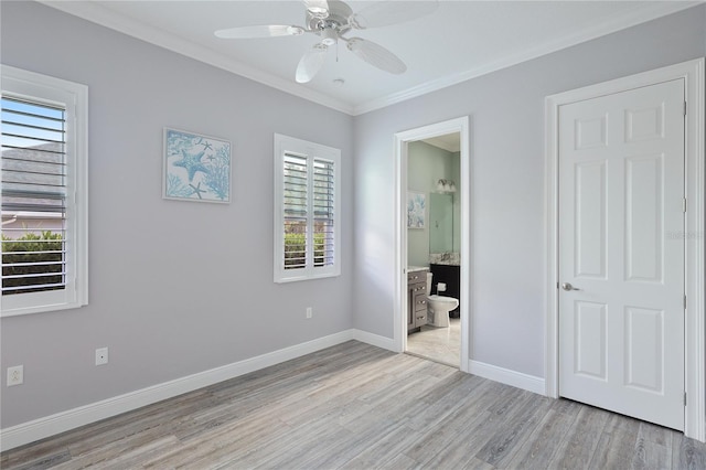 unfurnished bedroom featuring ensuite bathroom, ceiling fan, light hardwood / wood-style floors, and ornamental molding