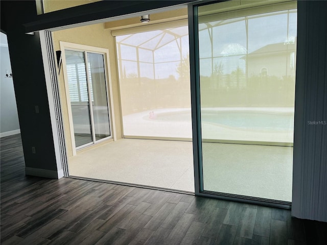 interior space with dark hardwood / wood-style flooring and a healthy amount of sunlight