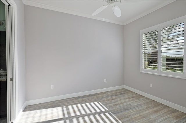 spare room with ceiling fan, a healthy amount of sunlight, ornamental molding, and light hardwood / wood-style flooring