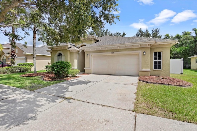 view of front of property with a front lawn and a garage