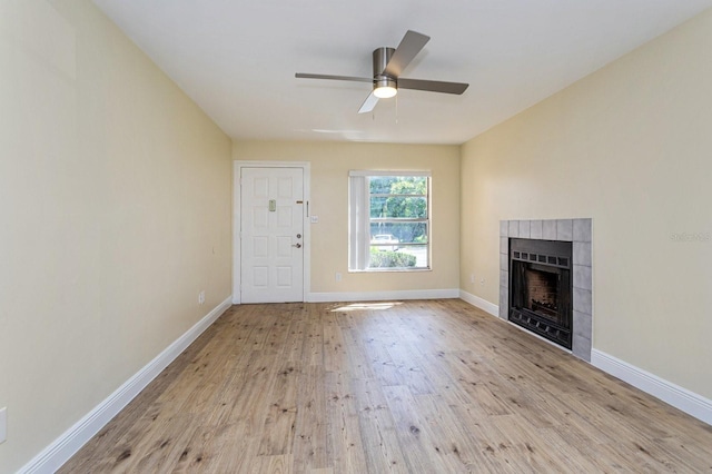 unfurnished living room with a fireplace, light hardwood / wood-style floors, and ceiling fan