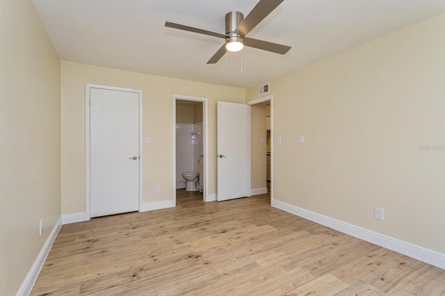 unfurnished bedroom featuring ensuite bath, ceiling fan, and light hardwood / wood-style flooring