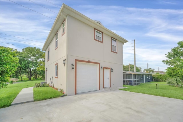 exterior space featuring a garage and a yard