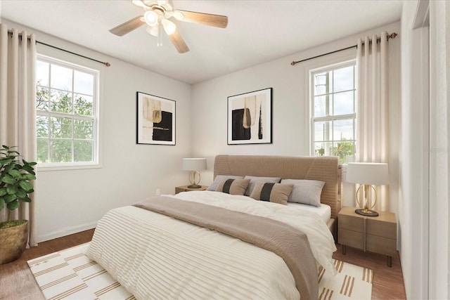 bedroom with a ceiling fan and baseboards