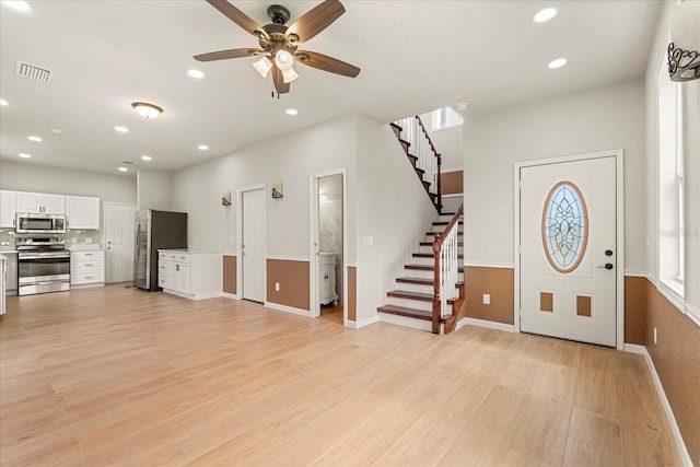 foyer featuring light wood-style floors, recessed lighting, visible vents, and stairway