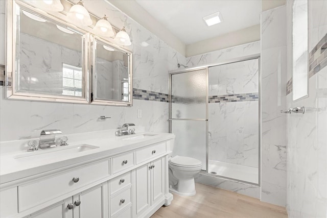 bathroom featuring double vanity, a sink, and a marble finish shower