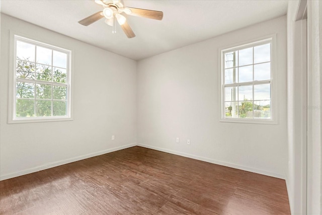 unfurnished room featuring a ceiling fan, baseboards, and wood finished floors