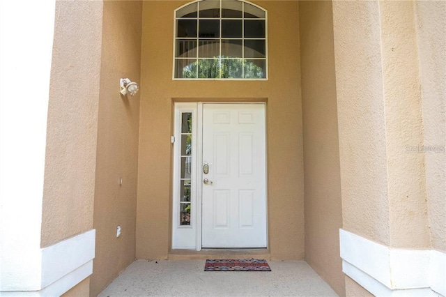 view of exterior entry with stucco siding