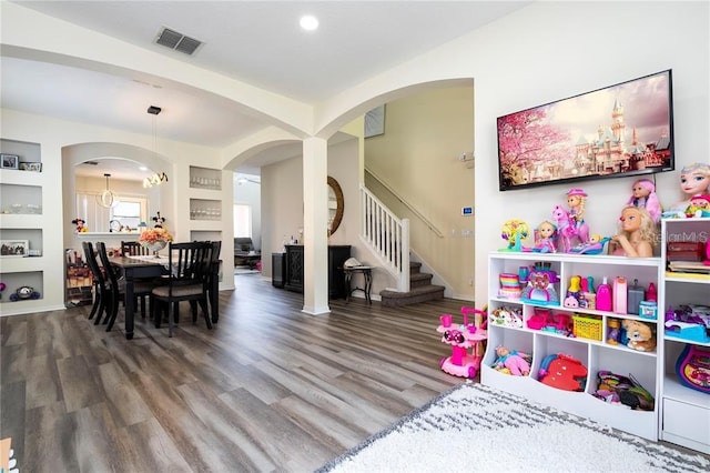 playroom featuring arched walkways, wood finished floors, visible vents, and recessed lighting