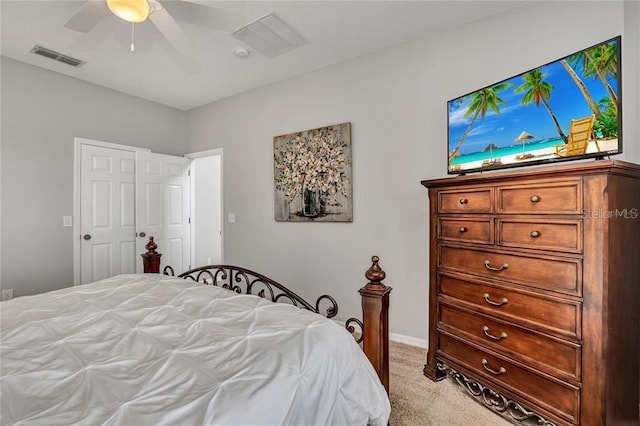 carpeted bedroom featuring ceiling fan and a closet