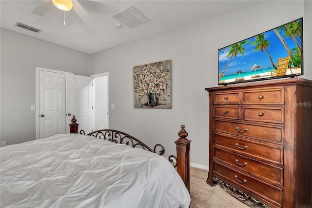 bedroom with ceiling fan, visible vents, and light carpet