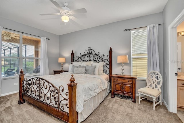 carpeted bedroom with ceiling fan and connected bathroom